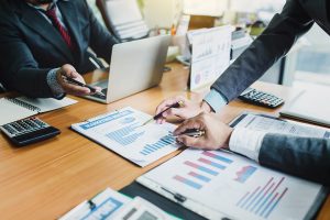 Group of business people meeting analyzing financial documents a