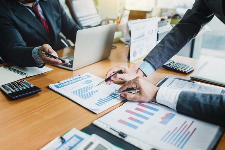 Group of business people meeting analyzing financial documents a